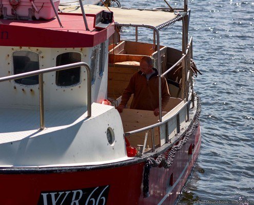 fisherman repairing his boat