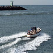 small boat leaving harbor