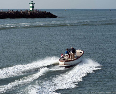 small boat leaving harbor