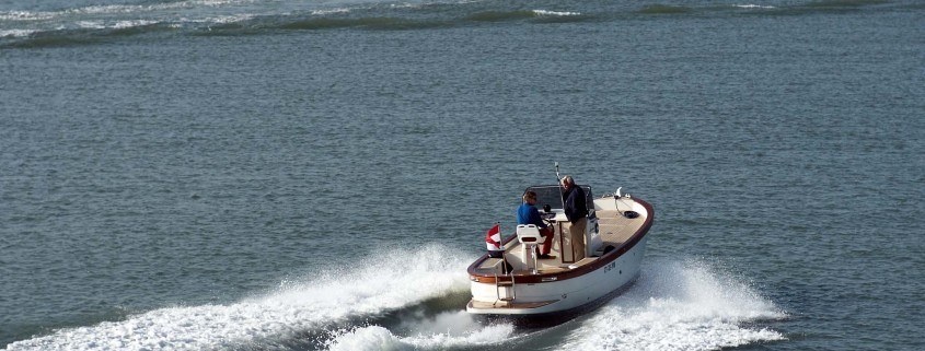 small boat leaving harbor