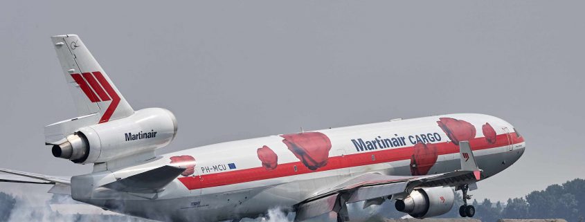 plane landing with smoke from the tires