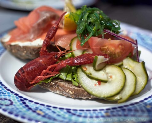 lunch dish with shrimp, salmon, cucumber, and bread